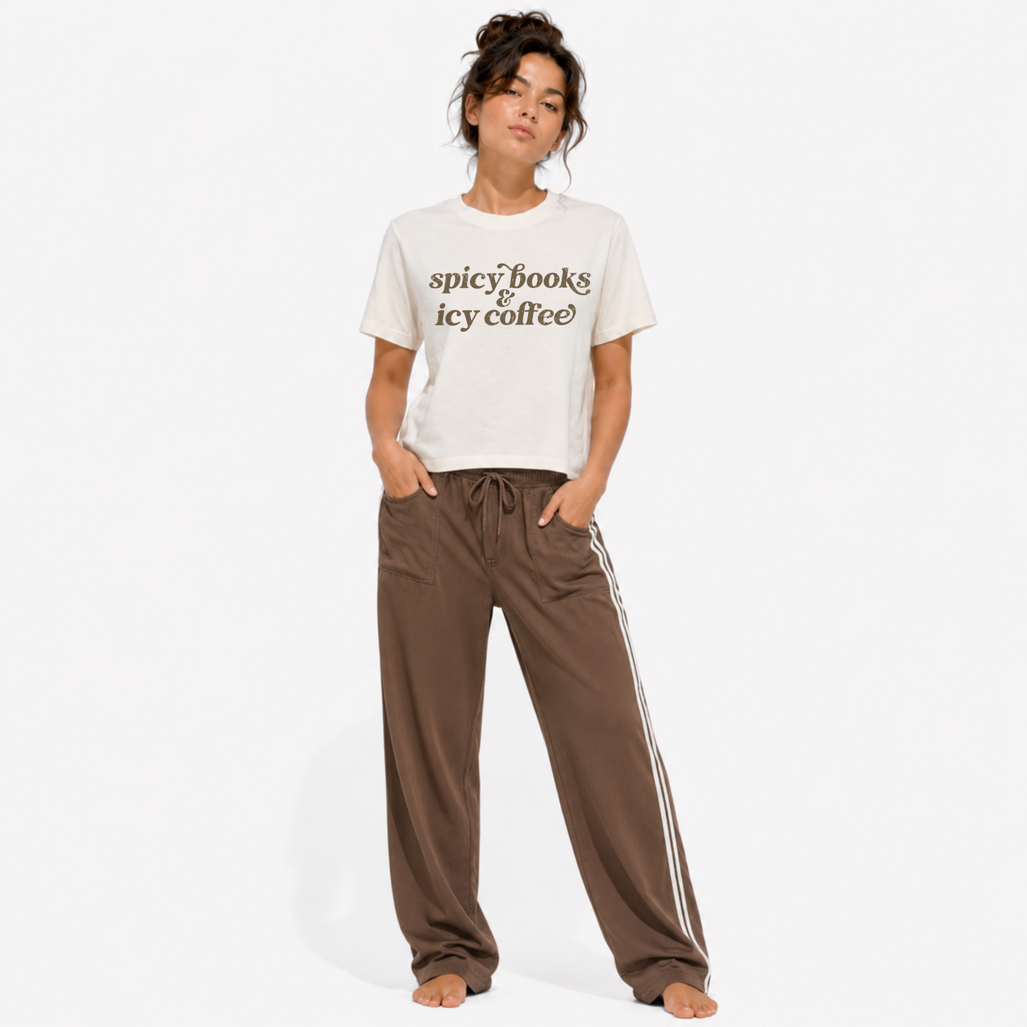 Close-up of the "Spicy Books & Icy Coffee" graphic printed on a women's washed garment-dyed t-shirt, highlighting the detailed typography and vintage-inspired print quality.