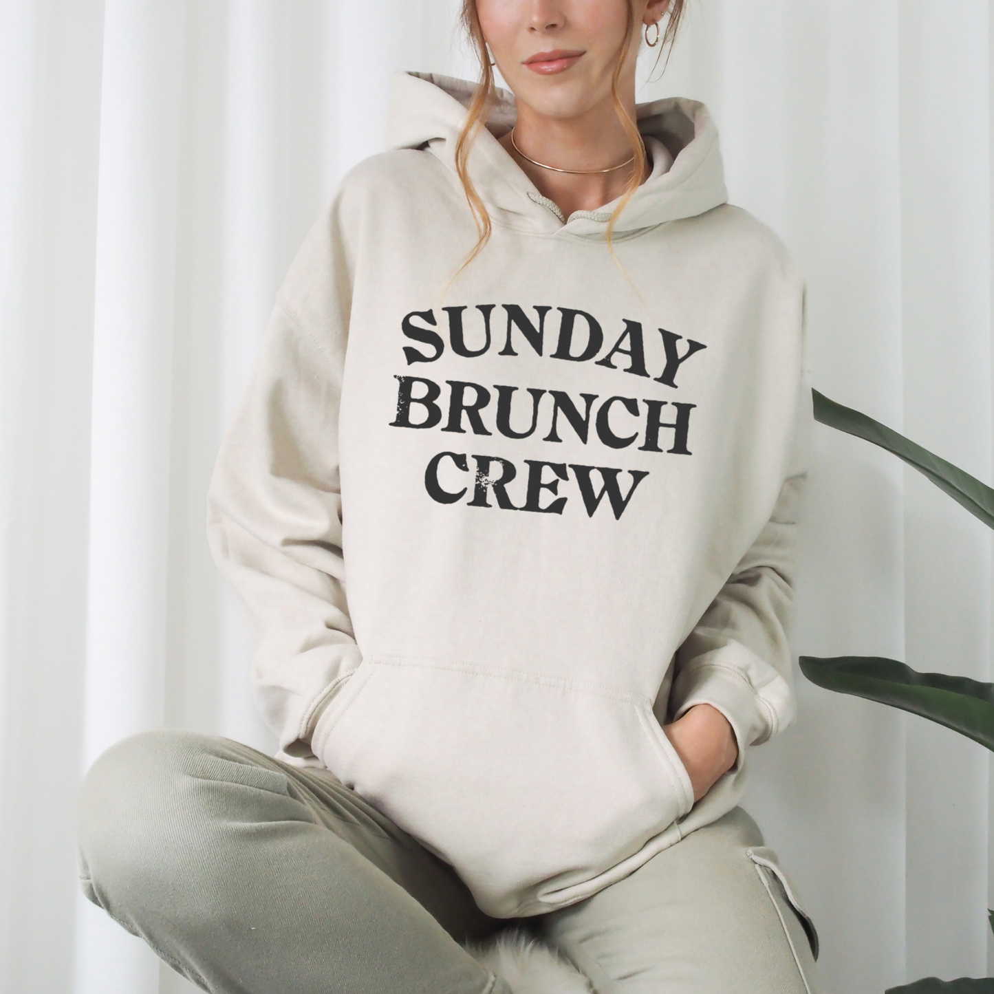 Unisex Sunday Brunch Club graphic hoodie styled for cozy fall brunch outfit. Soft fleece pullover in white pink gray and sand for relaxed weekend fashion