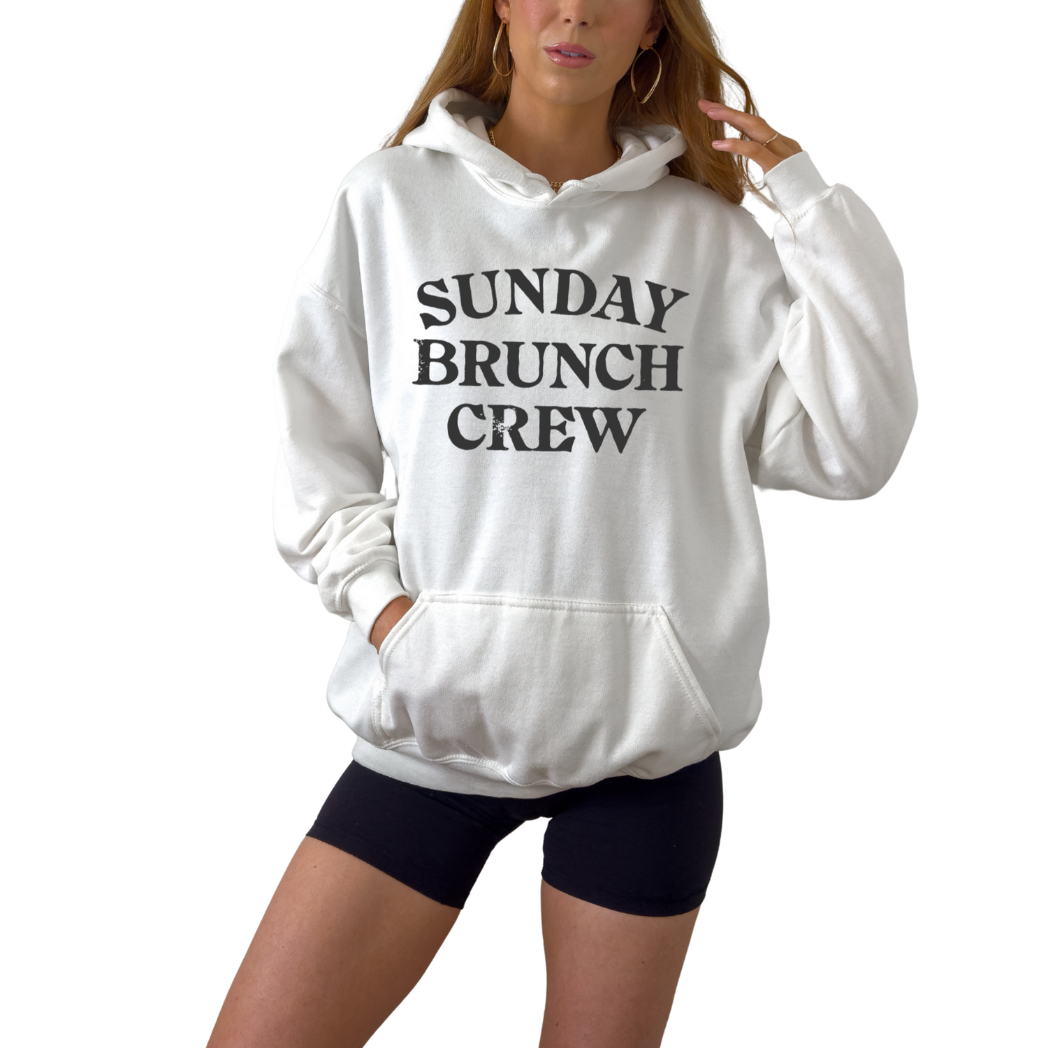 Unisex Sunday Brunch Club graphic hoodie styled for cozy fall brunch outfit. Soft fleece pullover in white pink gray and sand for relaxed weekend fashion