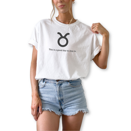 Taurus zodiac horoscope t-shirt featuring “This Is a Good Day to Stay In.” Cozy astrology shirt for April and May birthdays. Earth sign graphic tee for comfort-loving horoscope fans.