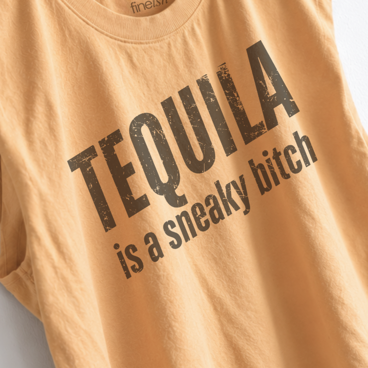 Women’s Tequila Is a Sneaky B*tch muscle tank featuring a funny tequila saying, perfect for margarita nights, girls trips, happy hour, and girls night. up close of eco friendly ink garment print