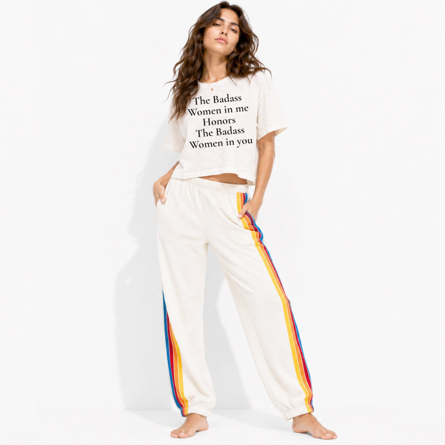 Woman wearing a boxy crop T-shirt featuring the phrase “The Badass Woman in Me Honors the Badass Woman in You.”