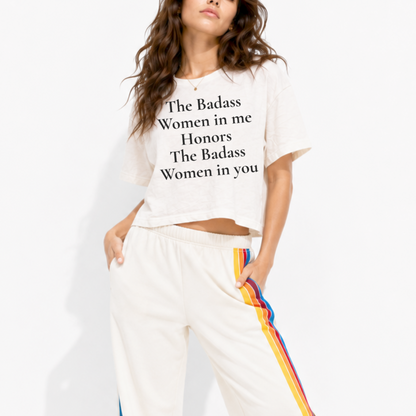 Close-up of “The Badass Woman in Me Honors the Badass Woman in You” printed on a women’s boxy crop T-shirt.
