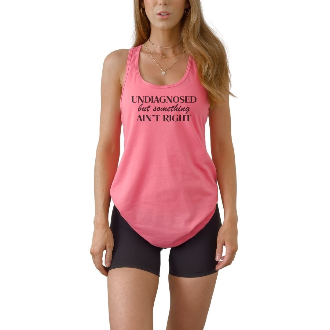 Women’s racerback tank with Undiagnosed but Something Ain’t Right quote. Lightweight fitted graphic tank for summer and workouts.