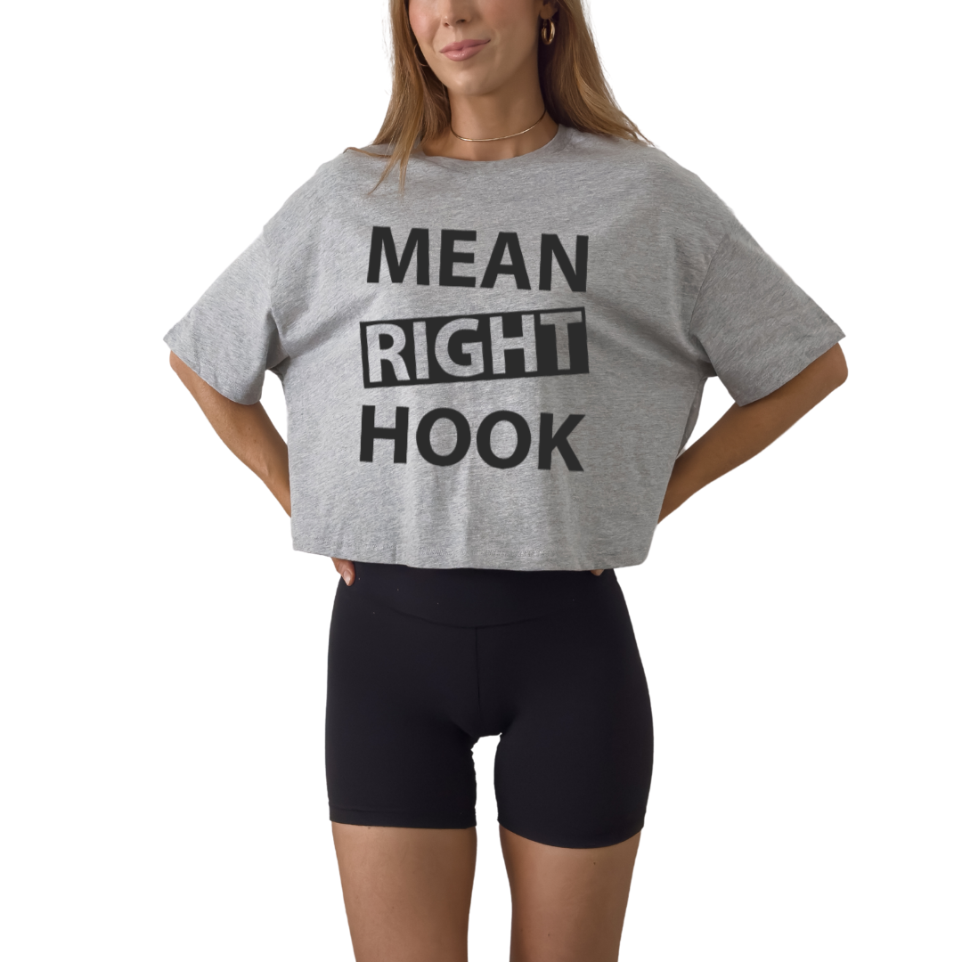 Women’s boxy cropped t-shirt featuring “Mean Right Hook” graphic design, trendy short-length tee with relaxed fit, perfect for streetwear outfits, bold fashion looks, and casual styling, soft breathable fabric ideal for everyday wear, modern cropped silhouette for confident style athletic workout shirt